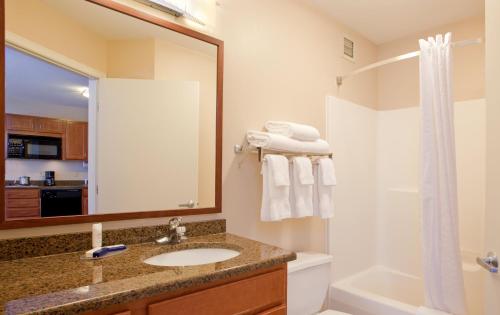 a bathroom with a sink and a mirror at Candlewood Suites Rockford, an IHG Hotel in Rockford