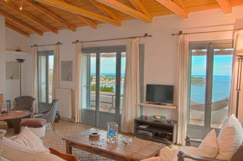 a living room with a view of the ocean at Villa Von Sophia / THE HOUSE in Áyioi Apóstoloi