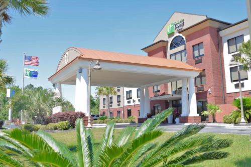 a rendering of a hotel with a building at Holiday Inn Express & Suites Pensacola West I-10 by IHG in Pensacola