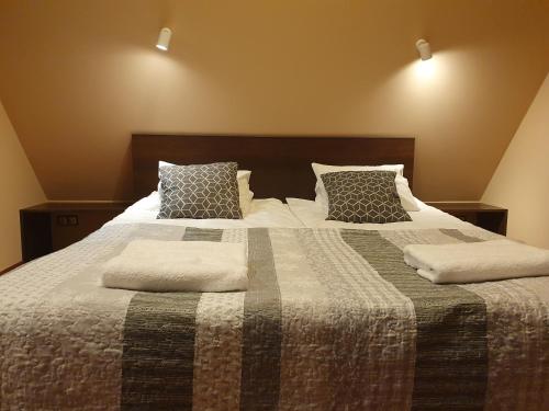 a bedroom with a bed with two pillows on it at Chata nad Sztolnią in Bystrzyca Górna