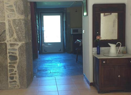 a hallway with a door to a room with a tile floor at CASA CONCHA in A Estrada