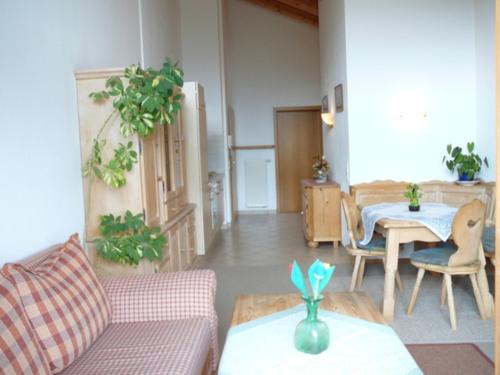 a living room with a couch and a table at Haus St_ Michael_ Ferienwohnung 1_4 in Schliersee