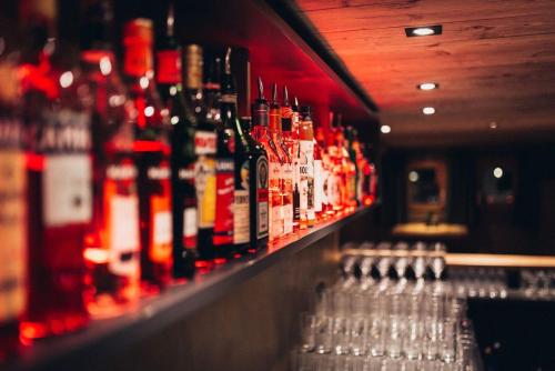 a row of bottles of alcohol on a bar at Der Löwe in Burgberg
