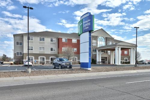 a car is parked in front of a building at Holiday Inn Express & Suites Portales by IHG in Portales