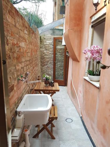 a bathroom with a white bath tub in a building at Ca' Marcella in Venice
