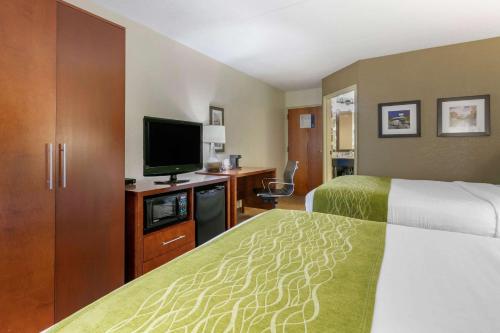 a hotel room with two beds and a flat screen tv at Comfort Inn Chattanooga Downtown Southside in Chattanooga