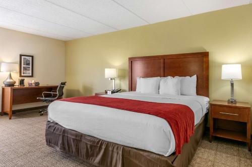 a hotel room with a large bed and a desk at Comfort Inn Chattanooga Downtown Southside in Chattanooga