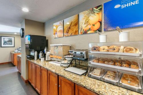a bakery with a counter with pastries on it at Comfort Inn Chattanooga Downtown Southside in Chattanooga