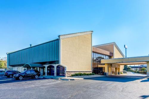 a building with a car parked in a parking lot at Hermitage Hotel Richmond Virginia in Richmond