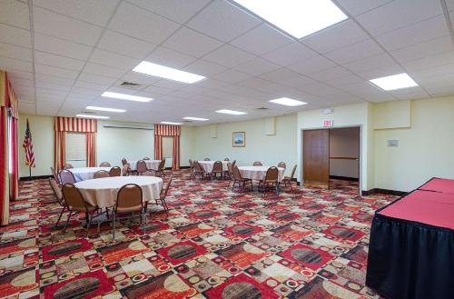 a conference room with tables and chairs and a podium at Quality Inn Easton in Easton