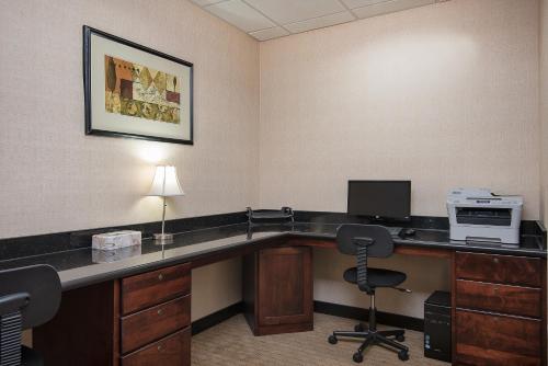 an office with a desk with a computer and a printer at Holiday Inn Express and Suites Lafayette East by IHG in Lafayette