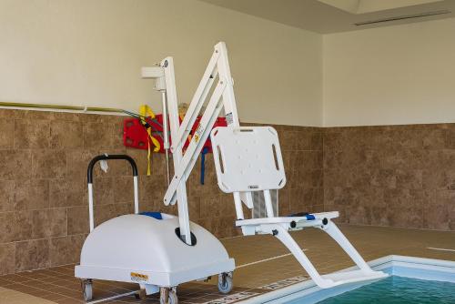 a massage machine in a room next to a swimming pool at Holiday Inn Express and Suites Lafayette East by IHG in Lafayette