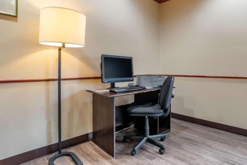an office with a desk with a computer and a lamp at Comfort Suites Airport in Jacksonville