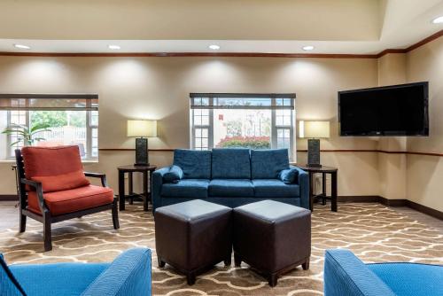 a living room with furniture and a flat screen tv at Comfort Suites Airport in Jacksonville