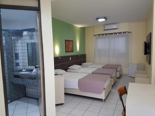 A bed or beds in a room at Hotel Recanto Wirapuru