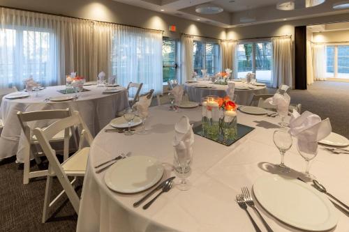a banquet room with white tables and chairs with white tablecloths at The Residences at Biltmore - Asheville in Asheville