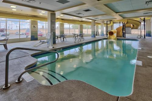 a large swimming pool in a building at Holiday Inn & Suites Albuquerque-North I-25 by IHG in Albuquerque
