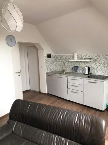 a living room with a couch and a kitchen at Apartement Zaventem in Zaventem