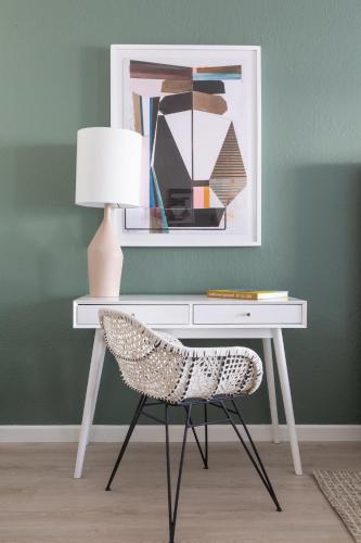 a white desk with a chair and a lamp at Signature Inn Oakland in Oakland