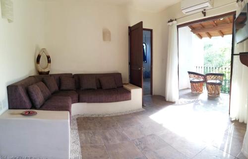 a living room with a couch and a table at Ceiba Studios in Zihuatanejo