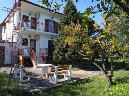 a bench and a table in front of a building at Manousi 1- Ground floor in Mystras