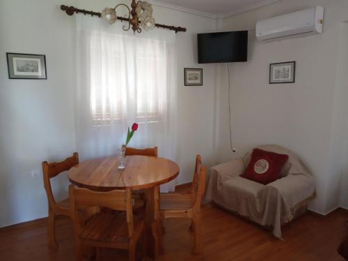 a living room with a table and a couch at Manousi 1- Ground floor in Mystras