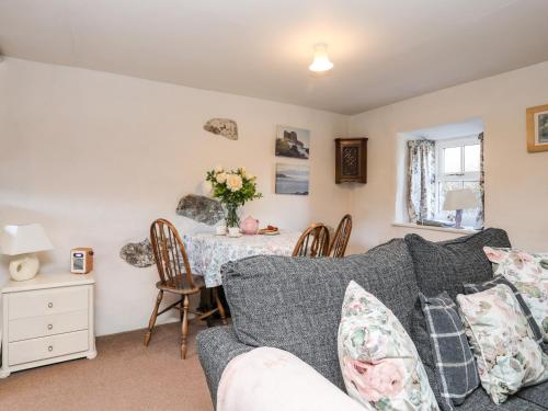 a living room with a couch and a table at Y Bwthyn in Criccieth