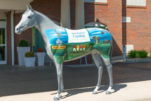 a statue of a horse with a sign on it at Holiday Inn Express & Suites Lexington Downtown Area-Keeneland by IHG in Lexington
