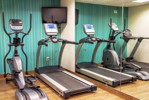 a gym with three exercise bikes in a room at Holiday Inn Express & Suites Lexington Downtown Area-Keeneland by IHG in Lexington