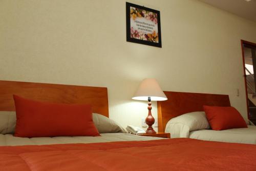 Ein Bett oder Betten in einem Zimmer der Unterkunft Hotel Señorial Tlaxcala