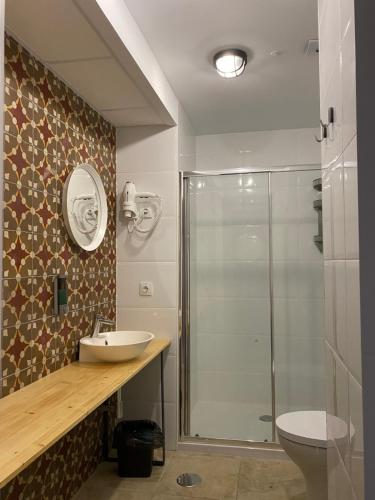 a bathroom with a shower and a sink and a toilet at Hostel Numero Trece - Albergue Juvenil - FREE towels, coffee & tea, remote check-in in Alicante