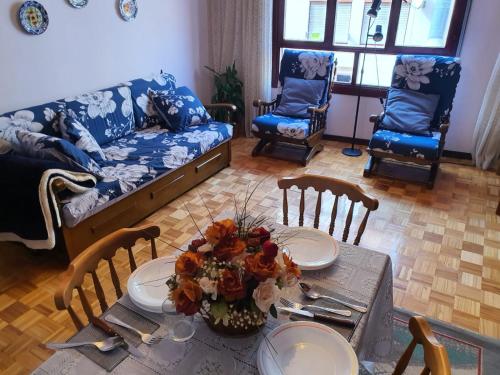 een woonkamer met een tafel en een bank bij Piso centro Luanco in Luanco