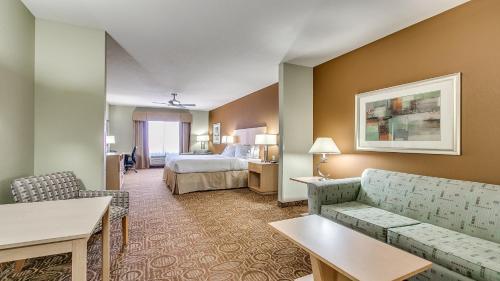 a hotel room with a bed and a couch at Holiday Inn Express & Suites Lubbock Southwest – Wolfforth by IHG in Lubbock