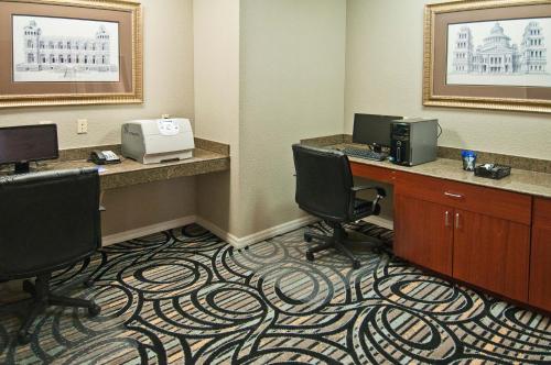 an office with a desk with two chairs and a printer at Holiday Inn Express Hotel and Suites Lake Charles by IHG in Lake Charles