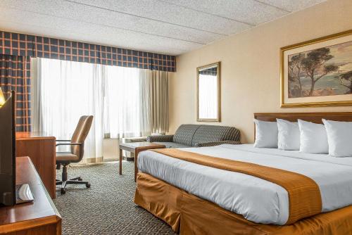 a hotel room with a bed and a desk at Quality Inn and Conference Center in Springfield