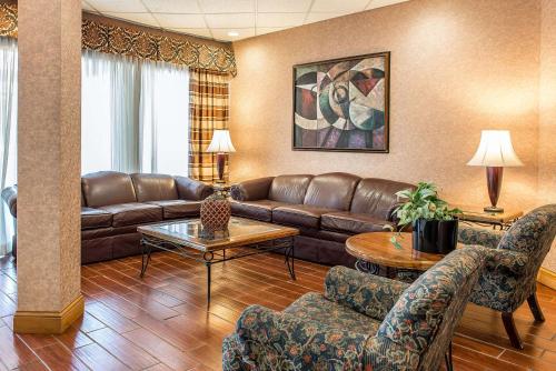 a living room with a couch and a table at Quality Inn and Conference Center in Springfield