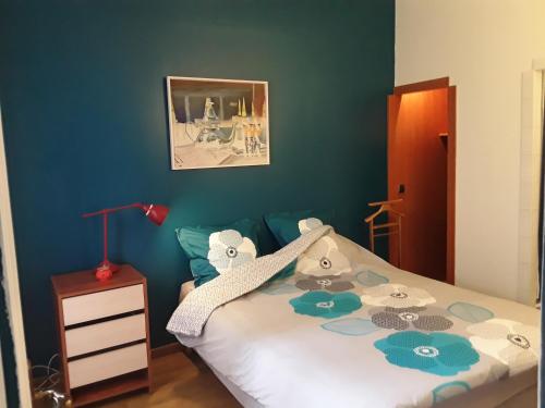 ヌイイ・シュル・セーヌにあるcosy rare 2 bedroom apartment around a private gardenの青い壁のベッドルーム1室