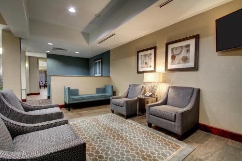 a waiting room with chairs and a projection screen at Holiday Inn Express Natchez South West by IHG in Natchez