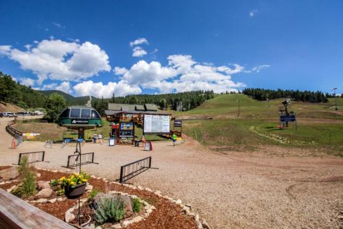 a playground in a field with a hill in the background at Gold Dust F3 in Angel Fire