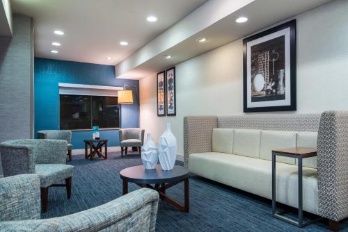 a waiting room with a couch and chairs at Holiday Inn Express & Suites Rocky Mount Smith Mountain Lake by IHG in Rocky Mount