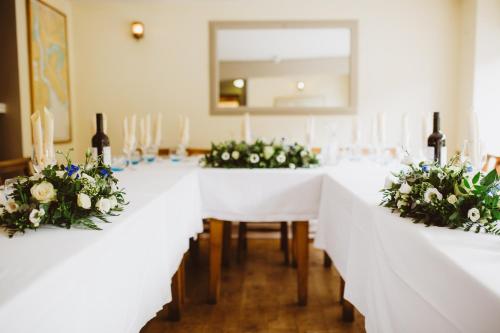 a long table with white flowers and wine bottles at The Maltsters Arms in Totnes