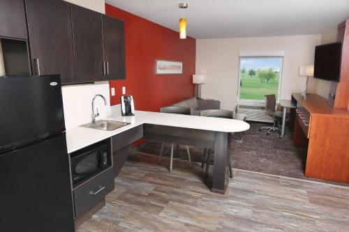 a kitchen with a sink and a counter top at Holiday Inn & Suites Sioux Falls - Airport by IHG in Sioux Falls