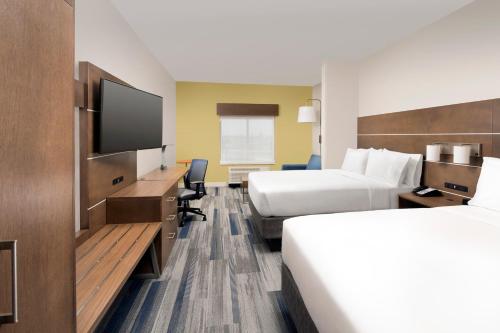 a hotel room with two beds and a flat screen tv at Holiday Inn Express & Suites San Antonio North-Windcrest by IHG in San Antonio