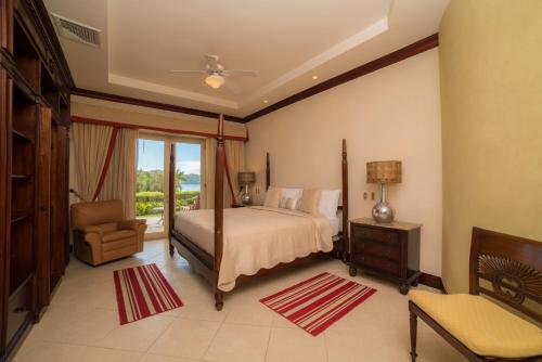 1 dormitorio con 1 cama, 1 silla y 1 ventana en Los Suenos Resort Bella Vista 4E - Family ONLY By Stay in CR, en Herradura
