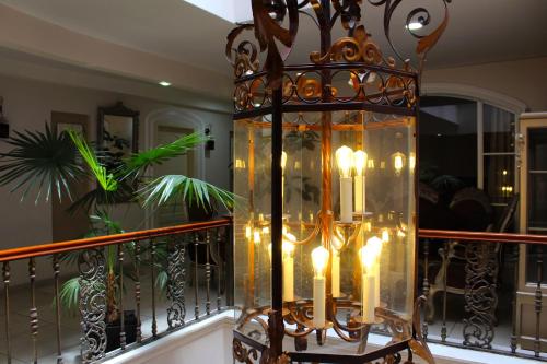 a chandelier with candles sitting on a balcony at Rio Hotel in Riobamba