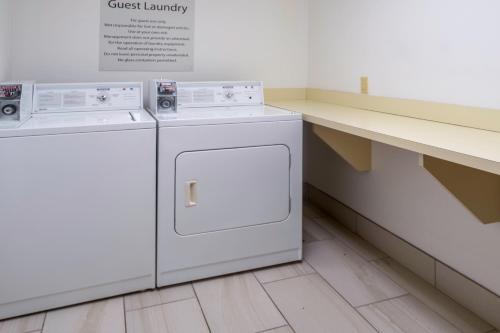 two washing machines are sitting in a laundry room at Holiday Inn Express Hotel & Suites Pasco-TriCities by IHG in Pasco