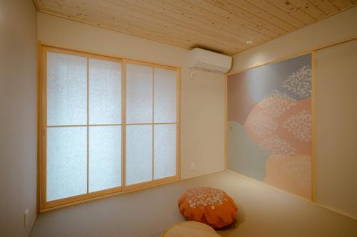 a room with a large window and a pillow at so, KANAZAWA in Kanazawa