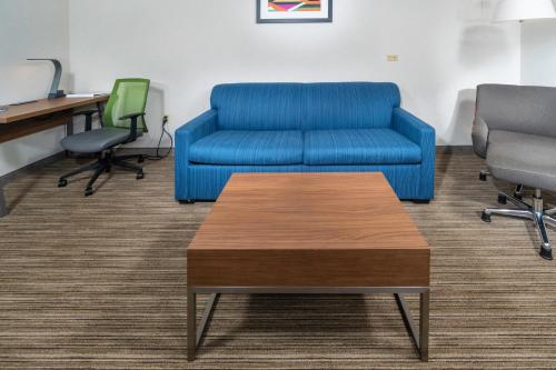 a living room with a couch and a table at Holiday Inn Express Hotel & Suites Pasco-TriCities by IHG in Pasco