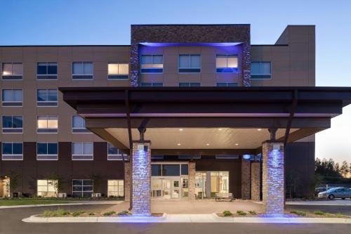 a rendering of a building with a sculpture in front at Holiday Inn Express & Suites Duluth North - Miller Hill by IHG in Duluth