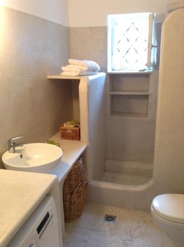 a bathroom with a sink and a toilet and a shower at Beach House in Zagora
